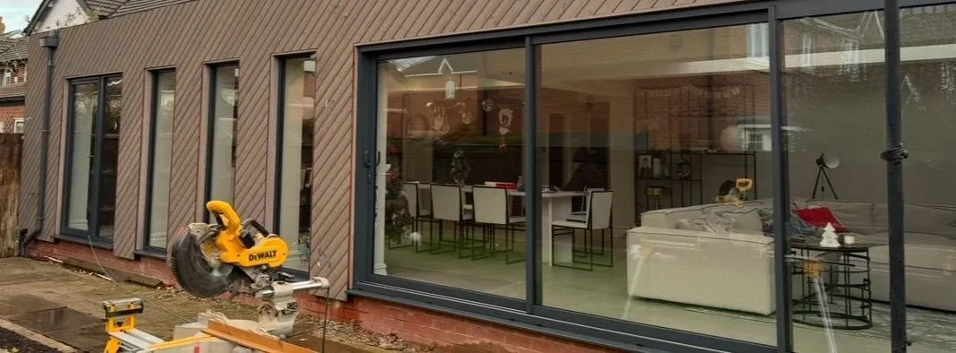 Diagonal timber-clad extension with full-height glazing