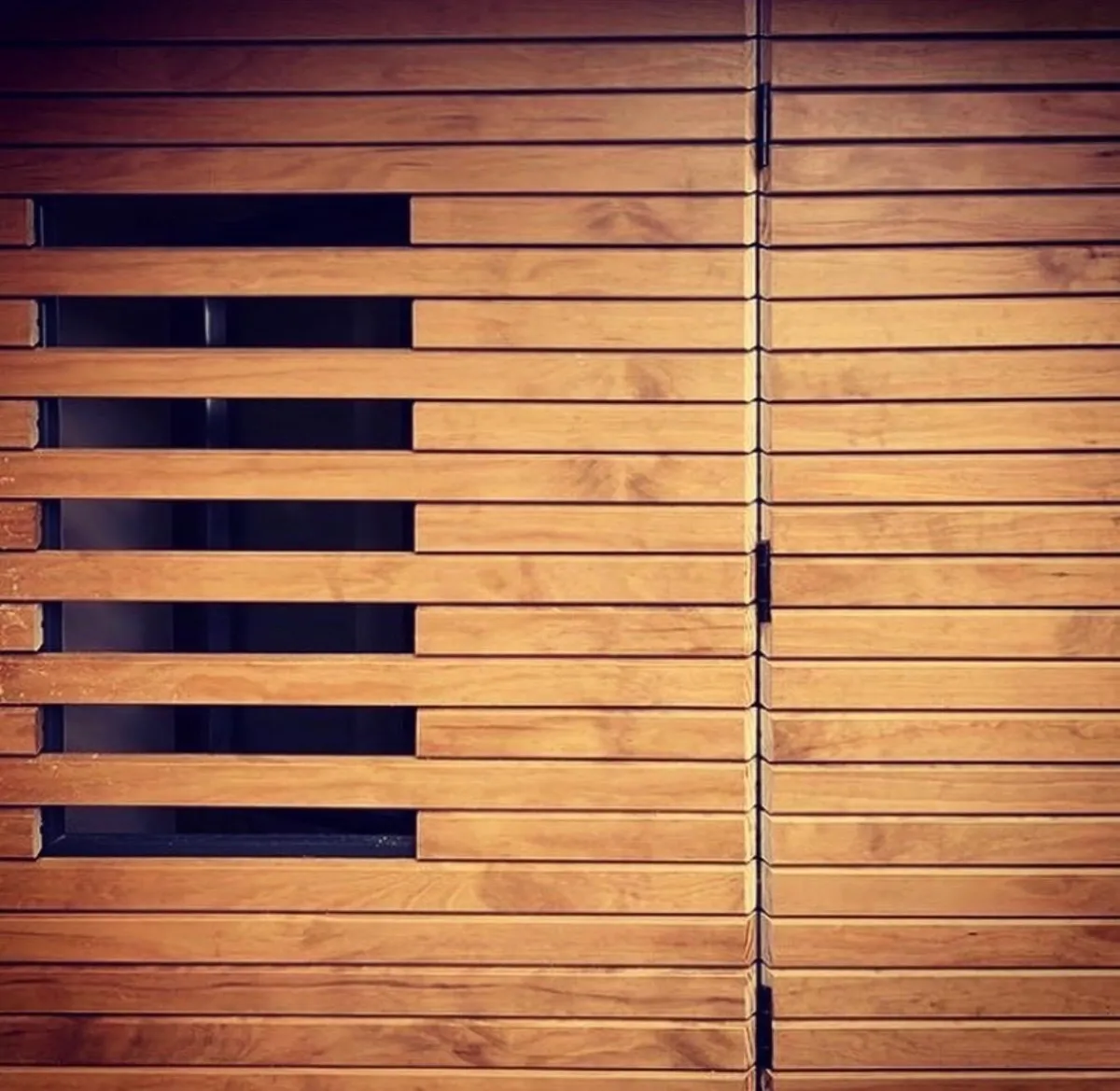 Timber-clad garden room with slatted horizontal window detail