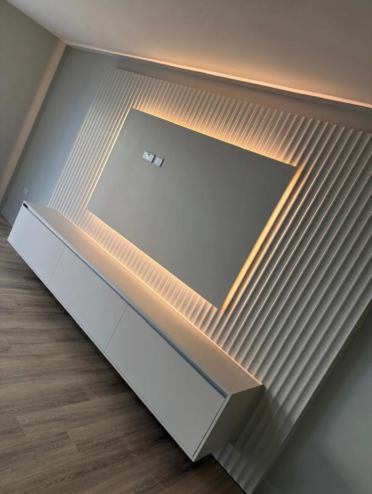 Bespoke joinery media wall with fluted timber panels